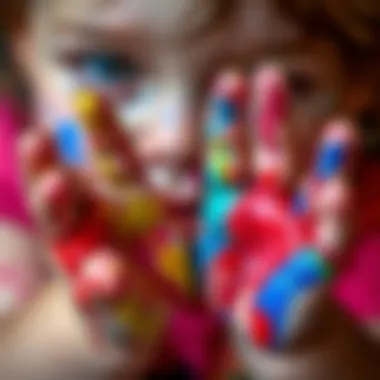 Close-up of colorful finger paint smeared on a child's hands
